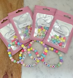 three bags filled with beads on top of a table