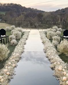 an outdoor ceremony setup with chairs and flowers