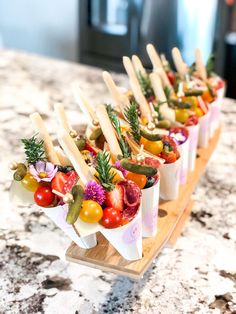 small trays filled with assorted fruits and veggies on wooden serving boards