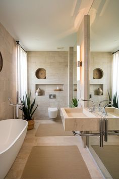 a large bathroom with two sinks and a bathtub