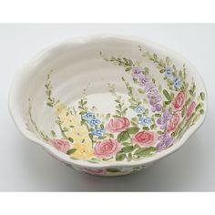 a white bowl with flowers painted on it