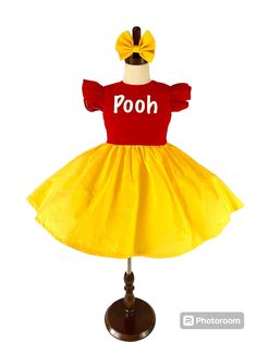 This adorable Winnie the Pooh inspired dress is perfect for any special occasion, or even as a cute play dress. The special girl in your life will want to twirl all day in this beautiful dress.    This dress is made with soft cotton fabric, is professionally lined and serged and comes with a cute matching bow.   Dress is made with flutter sleeves. In the personalization box please let me know what word In vinyl you would like for the front on the dress. For example dress pictured is personalized Cute Yellow Dress For Costume Party, Cute Short Sleeve Princess Dress For Birthday, Cute Fitted Princess Dress For Easter, Cute Red Princess Dress For Birthday, Princess Dress With Short Sleeves For First Birthday, Princess Style Dress With Short Sleeves For First Birthday, Playful Red Dress For First Birthday, Cute Yellow Dress For First Birthday, Fun Red Birthday Dress