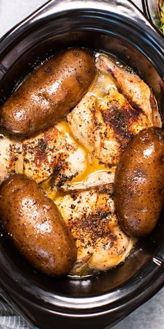 some chicken and potatoes in a crock pot next to a bowl of broccoli