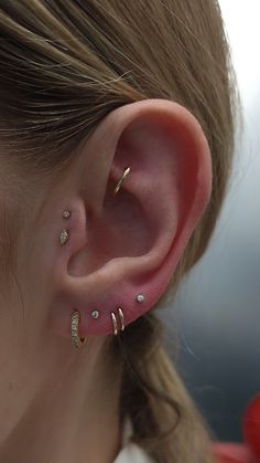 a close up of a person with ear piercings