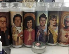 several candles with pictures of people on them