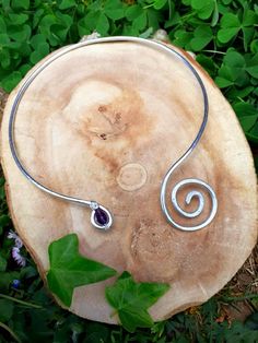 Celtic inspired torque collar necklace. Made with aluminum wire adorned with spirals and a purple glass bead Adjustable. Our jewellery,bracelets,rings and necklaces are inspired by ancient art and are totally handmade. For a costum order just contact me! HANDMADE WITH LOVE! Spiritual Spiral Metal Jewelry, Handmade Purple Spiral Jewelry, Torque Necklaces, Torque Necklace, Rings And Necklaces, Jewellery Bracelets, Celtic Art, Neck Jewellery, Wrapped Jewelry