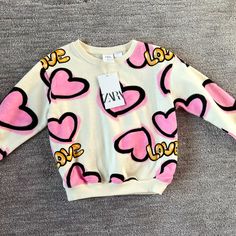 Brand New With Tags Zara Toddler Girls Size 3-4 Graffiti Heart Love Sweatshirt Pink Long Sleeve T-shirt With Heart Graphic, Pink Long Sleeve Tops For Playtime, Sweet Long Sleeve Tops With Graphic Print, Sweet Long Sleeve Graphic Print Top, Pink Letter Print Tops For Playwear, Playful Pink Tops For Babies, Cute Pink Tops For Playwear, Sweet Pink Tops With Cartoon Print, Cute Long Sleeve Top With Heart Graphic