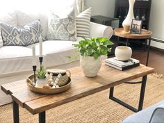 a living room filled with furniture and a wooden table in front of a white couch