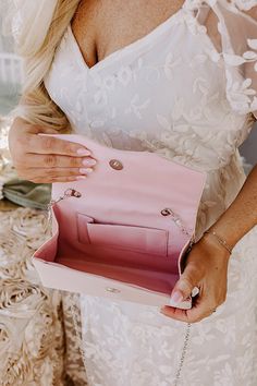 - Feel fabulously feminine with this gorgeous purse! - A fully lined rectangular pouch - Silver hardware - A faux pearl handle as well as a detachable chain shoulder strap - An interior pocket - A rhinestone bow detail - Flap/button closure Pink Rectangular Evening Bag With Pearl Handle, Pearl Handle Clutch For Wedding Guests, Feminine Shoulder Bag With Detachable Strap For Parties, Pink Evening Bag With Pearl Handle For Party, Pink Rectangular Clutch With Chain Strap, Pink Crossbody Evening Bag With Chain Strap, Blush Rectangular Bag For Parties, Feminine Shoulder Bag With Removable Pouch For Party, Feminine Shoulder Evening Bag For Party