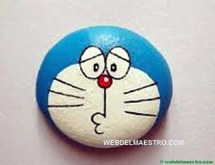 a close up of a blue and white cat face on a button with red nose