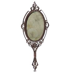 an antique mirror with ornate metal frame