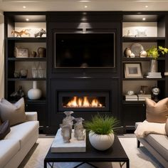 a living room filled with furniture and a flat screen tv mounted on the wall above a fire place