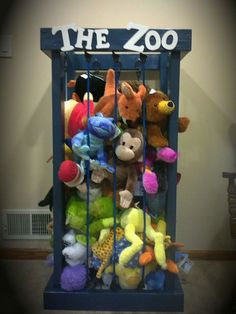 stuffed animals in a cage with the word the zoo written on it's side