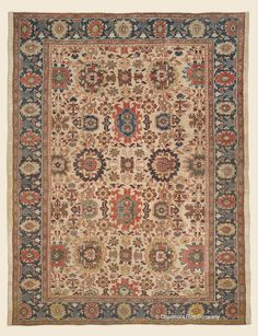 an antique rug with many different colors and designs