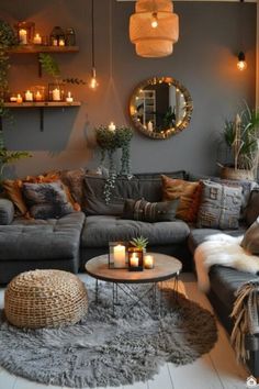 a living room filled with lots of furniture and candles on top of the couches