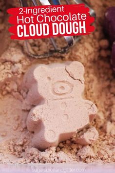 there is a teddy bear made out of clay in the sand with text overlay that reads 2 ingredient hot chocolate cloud dough