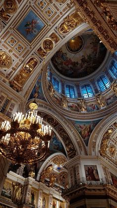 an ornate ceiling with chandeliers and paintings on it