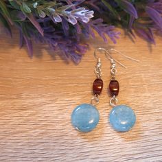 These earrings are a combination of sky and ground....with an ocean blue round disk bead and an earthtone brown color bead. The sky and ground colors  compliment eachother.  They have a boho style, with a modern look.  These were designed and handcrafted by me at my little table.🌺    Thank you for clicking on me!! Please see the other jewelry I am selling...   https://www.etsy.com/shop/paulinesetsy 😊*Smoke free home* 😊 Bohemian Blue Beaded Earrings With Natural Stones, Bohemian Brown Beaded Round Earrings, Brown Earrings With Natural Stones And Round Beads, Blue And Brown, Bead Earrings, Ocean Blue, Earth Tones, Blue Ocean, Boho Style