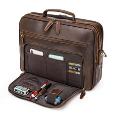 a brown briefcase with two compartments and some pens