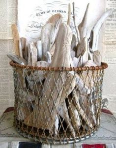 a basket filled with driftwood sitting on top of a table