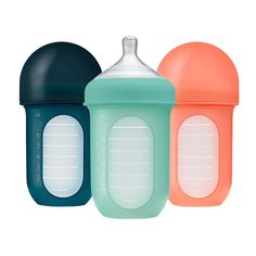 three baby bottles in different colors on a white background