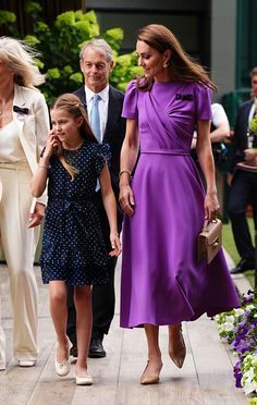 the queen and her family are walking together