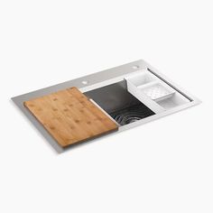 a wooden cutting board sitting on top of a sink