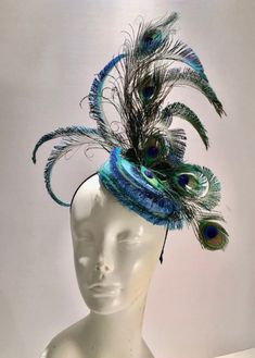 "Derby Fascinator -Peacock Fascinator- peacock hat -wedding -Ascot -Melbourne Cup- Mad hatter-  Hello,   This is a wonderful peacock hat. This feather peacock fascinator hat is on a Ombre straw circle. It has turquoise, navy, gold, green colors. The feather peacock plumes have so many colors in them. The peacock  is about 9\" high.  The whole piece is on a 1/8\" headband that is covered with 1/8\"satin. It's adjustable and very comfortable. Plus no hat head!  It's a fun piece. ------------------ Blue Feather Headpiece For Kentucky Derby, Peacock Derby Hat, Blue Feather Fascinator For Kentucky Derby, Elegant Blue Feathered Costume Hats And Headpieces, Steampunk Fascinator, Peacock Outfit, Fascinator Designs, Peacock Feather Hat, Peacock Headpiece