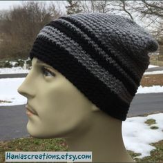 a mannequin head wearing a black and gray knitted hat on top of it's head