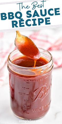 the best bbq sauce recipe in a mason jar with a spoon sticking out of it