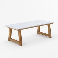 a white marble table with wooden legs