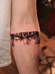 a man's arm with an eye tattoo on it