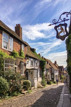 a cobblestone street lined with brick buildings