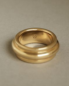 two gold rings sitting on top of each other