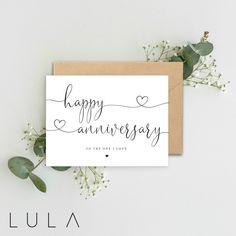 a card with the words happy anniversary written in cursive writing on it and flowers