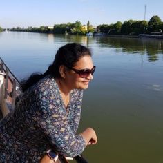 a woman riding on the back of a boat