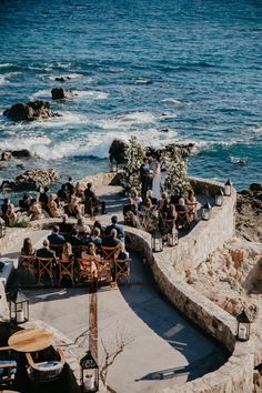 A beautiful beachside wedding set-up at the Esperanza resort in Cabo San Lucas, with blue ocean waves and palm trees in the background. The decor features colorful floral arrangements, elegant table settings, and romantic string lights creating a magical ambiance. #love #wedding #weddingplanner #weddingplanning #destinationwedding #mexico #loscabos #luxury #luxurywedding Beach Castle Wedding, Wedding By The Ocean, Greece Beach Wedding, Beach Resort Wedding, Destination Wedding Ceremony, Beachfront Wedding, Wedding By The Sea, Argentina Wedding