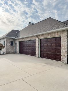 a large house with two garages on each side