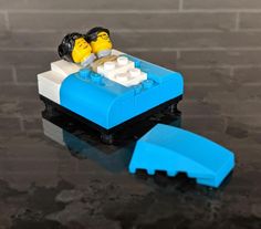 there is a lego boat with two people in it