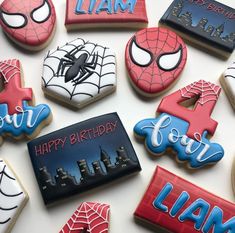 decorated cookies with spiderman and happy birthday names on top of each cookie in the shape of letters