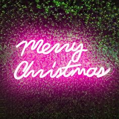 a neon sign that says merry christmas on it