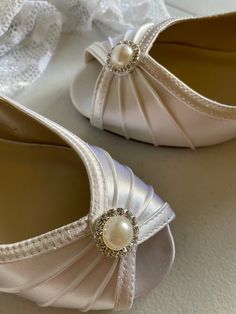 "Comfy wedge adults shoes available in US Size: 5, 5.5, and 6 REGULAR AND WIDE WIDTH ideal for Brides, Jr. Bridesmaids, First Communion older girls, and Confirmations. or any special occasion. Shoes feature a beautiful pearl with rhinestones around it! 1\" wedge heel. Please contact with help with sizing, or custom color, or need a different adornment brooch. PLEASE CONTACT FOR OTHER WEDGE STYLES IN ALL SIZES. THIS link is for a similar style in other sizes. https://www.etsy.com/listing/96244410 Classic White Round Toe Wedding Shoes, Classic White Wedding Shoes With Round Toe, Classic White Closed Toe Wedding Shoes, Classic White Almond Toe Wedding Shoes, Classic White Wedding Shoes With 4-inch Heel, Classic White Open Toe Wedding Shoes, Pearl White Round Toe Wedding Shoes, White Wedge Shoes, Wedges Shoes Low