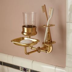 a toothbrush and cup holder on the wall