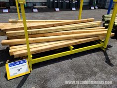 a pile of wood sitting on top of a yellow rack