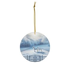 a christmas ornament with two horses in the snow