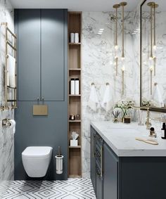 a bathroom with marble walls and flooring is shown in this image, there are gold accents on the shelves above the toilet