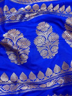 SILK MARK CERTIFIED !!Gorgeous Pure Katan Royal Blue Color with Copper and Slier Zari Work. Strips Sarees in Copper and Sliver Zari with Floral Buttas on the Pallu Soft, light weight and easy to drape Saree. The Strips are dense towards the pallu and get scattered the other end. Item : SareeColor : Royal Blue ColorBase Fabric : Pure Katan Silk Blouse piece : Comes with Blouse pieceBlouse material : Pure Katan SilkFall & Edging (Yes/No) : YesComes with Silk Mark Certificate (Yes/No) : Yes Disclai Blue Zari Weaving Blouse Piece For Party, Blue Party Blouse With Zari Weaving, Blue Traditional Wear With Unstitched Blouse For Celebration, Bollywood Style Blue Blouse Piece For Celebration, Blue Zari Work Blouse Piece For Celebration, Bollywood Blue Sets With Zari Weaving, Celebration Blue Blouse Piece With Zari Work, Blue Blouse Piece With Zari Work For Celebration, Blue Festive Traditional Wear For Celebration