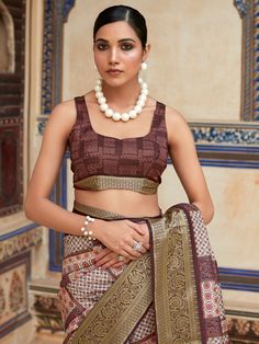 This gorgeous brown digital printed silk function wear saree with blouse is the perfect choice for any special occasion. Made from high-quality silk material, this saree comes in a beautiful brown color that complements a variety of skin tones. The digital print work and zari weaving add a touch of elegance and sophistication to the saree, making it a stunning addition to your ethnic wardrobe.
The saree measures 5.50 meters in length, providing you with plenty of fabric to drape in your preferre Festive Brown Blouse Piece, Brown Blouse Piece For Wedding Diwali, Brown Blouse Piece For Wedding And Diwali, Brown Wedding Blouse For Diwali, Unstitched Brown Saree For Festivals, Brown Saree With Pallu For Festivals, Brown Saree With Pallu For Diwali, Traditional Brown Saree For Navratri, Elegant Brown Saree