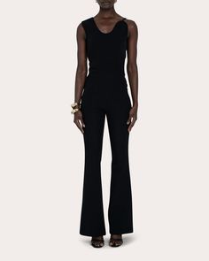 Embodying Filiarmi's sculptural aesthetic, the Brandy jumpsuit frames its scooped neckline with a wide strap at one shoulder and a slim one across the other. Cinched at the waist, the silhouette fits slim throughout the hips and thighs before flaring gently at the hems. Zip closure Asymmetric neckline Fitted waistline Darted bodice seams Slim legs Flared hems Heavy stretch crepe Self: 100% polyester Lining: 100% polyester Dry clean only Made in Turkey Size & Fit Model (wearing size FR 36 / US 4) Fitted Elastane Jumpsuits And Rompers For Evening, Fitted Jumpsuit With Asymmetrical Neckline For Evening, Evening Fitted Jumpsuit With Asymmetrical Neckline, Fitted Evening Jumpsuit With Asymmetrical Neckline, Sleek Fitted Sleeveless Pantsuit, Crepe Jumpsuit, Asymmetric Neckline, Scooped Neckline, Turkey Size