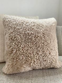 a white pillow sitting on top of a couch